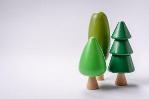 Wooden model of a tree with a green crown and trunk on a white background photo