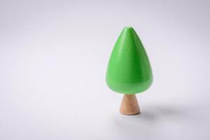 Wooden model of a tree with a green crown and trunk on a white background photo