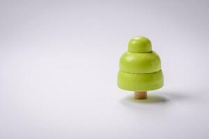 Wooden model of a tree with a green crown and trunk on a white background photo