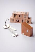 A small wooden house and keys as an idea for investing in your own home photo