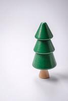 Wooden model of a tree with a green crown and trunk on a white background photo