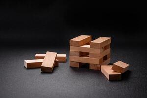 Wooden blocks of Jenga game as a concept idea of risk in achieving a goal photo