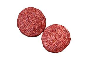 Fresh raw ground beef burger patty with salt and spices photo