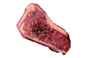 Fresh juicy raw new york beef steak with salt, spices and herbs photo