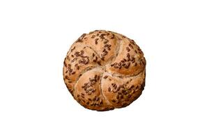 Delicious freshly baked crispy bun or kaiser roll with sesame seeds photo