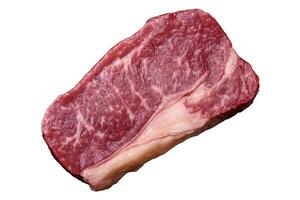 Fresh raw beef striploin steak with salt, spices and herbs photo