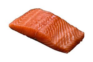 Fresh raw salmon red fish fillet with salt and spices photo