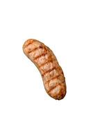 Delicious grilled sausages from chicken or pork meat with salt, spices and herbs photo