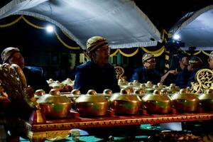 A man perform with wayang or traditional javanese puppet on stage at night. Tuban, Indonesia - 22 September, 2023. photo