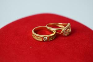 Close Up Golden ring with diamond on red carpet Background photo