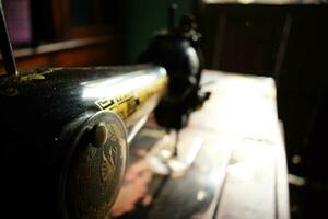 Tuban, Indonesia. September 7, 2023. An antique Butterfly Sewing Machine on the wooden desk. Vintage, Old, Retro Sewing Machine photo