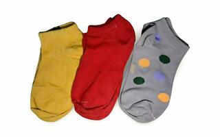 three pairs of colorful socks with dots on them photo