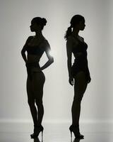 AI generated Silhouette of three women in black and white dresses, studio shot. ai generative photo