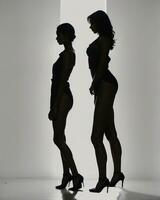 AI generated Silhouette of three women in black and white dresses, studio shot. ai generative photo