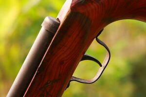 Hunting rifle close-up on a blurred background of nature. photo