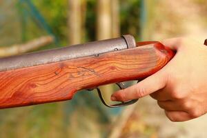 Hunting rifle in hand, closeup of photo with selective focus