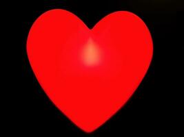 Closeup decorate lamp in red heart shape isolate on black background. photo