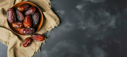 AI generated dates in a bowl on a cloth on a black background photo