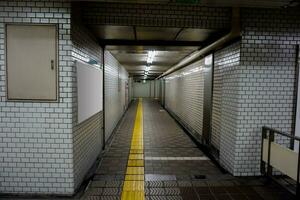 Perspective view and interiors of walk way at the Osaka subway station in midnight time. It's look horror and scary. photo