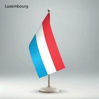 Flag of Luxembourg hanging on a flag stand. vector