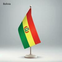 Flag of Bolivia hanging on a flag stand. vector