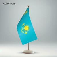 Flag of Kazakhstan hanging on a flag stand. vector