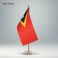 Flag of East Timor hanging on a flag stand. vector