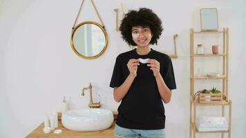 Skin Care, Cosmetics at Home, Natural Cream, Spa Treatments, Mixed Race. Afro american woman sticks eye patches while standing in bathroom video