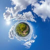 simple tiny planet without buildings in blue sky with beautiful clouds. Transformation of spherical panorama 360 degrees. Spherical abstract aerial view. Curvature of space. photo