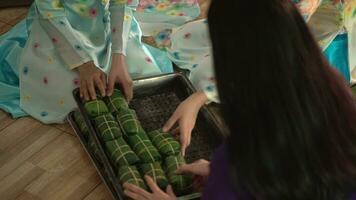 Close-up hand women in traditional costumes produce Vietnamese pork sausages, Vietnamese food. video