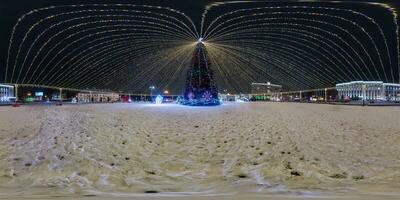 night full 360 panorama on square with Christmas tree with illumination in form of tent on new Year in equirectangular projection with zenith and nadir. VR AR content photo