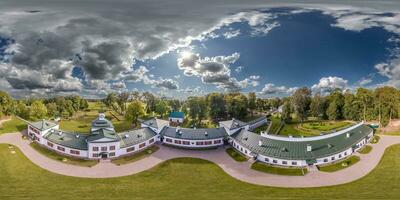 aerial seamless spherical 360 panorama overlooking restoration of the historic castle or palace near lake in equirectangular projection photo