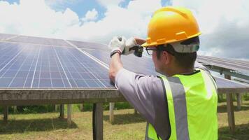 A workers technicians install heavy solar photovoltaic panels. video