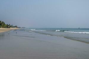 foam of sea or ocean waves against the backdrop with palms photo