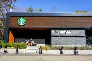 Osaka City, Japan, 2019 - Japanese lover with Starbucks Coffee Shop at Osaka Castle Park on blue sky background. photo