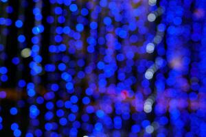 Abstract blurred and bokeh of party blue LED reflection lighting on night time background. photo