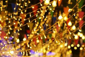 Blurred and bokeh of LED party lights and refection lighting on night time background photo