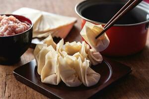 Raw Chinese dumpling by homemade and fill minced pork in dumpling photo