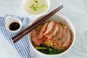 Barbecue roasted duck on noodles with gravy sauce, traditional Chinese food photo