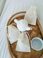 Mockup of cotton bags on a tray with a teapot. Eco concept photo