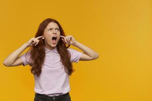 girl standing over yellow background photo