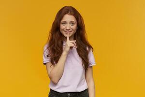 girl standing over yellow background photo