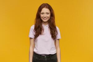 girl standing over yellow background photo