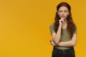 Ginger girl standing over yellow background photo