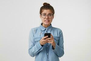 Woman in a panic realizes that she wrote a message, sent the text to the wrong recipient, received a message that the guests would soon arrive, has problems, nervous, worried. photo