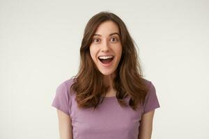 Close-up portrait of funny good-looking european with dark hair smiling broadly and staring at camera. Girl addicted with sweets and can not resist from buying kilos of them when goes shopping photo