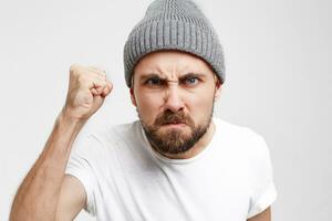 Neighbor standing in front of door, came to argue, angry, with a raised fist, came to knock on the door see-through the peephole, waiting until open, came complaining about the noise, white background photo