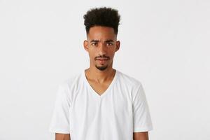 Closeup of irritated african american young man with afro hairstyle wears t shirt photo