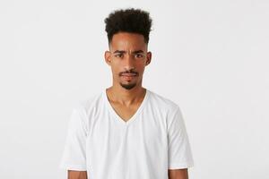 Portrait of angry serious african american young man with afro hairstyle wears photo