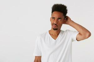 Portrait of pensive confused african american young man with afro hairstyle photo